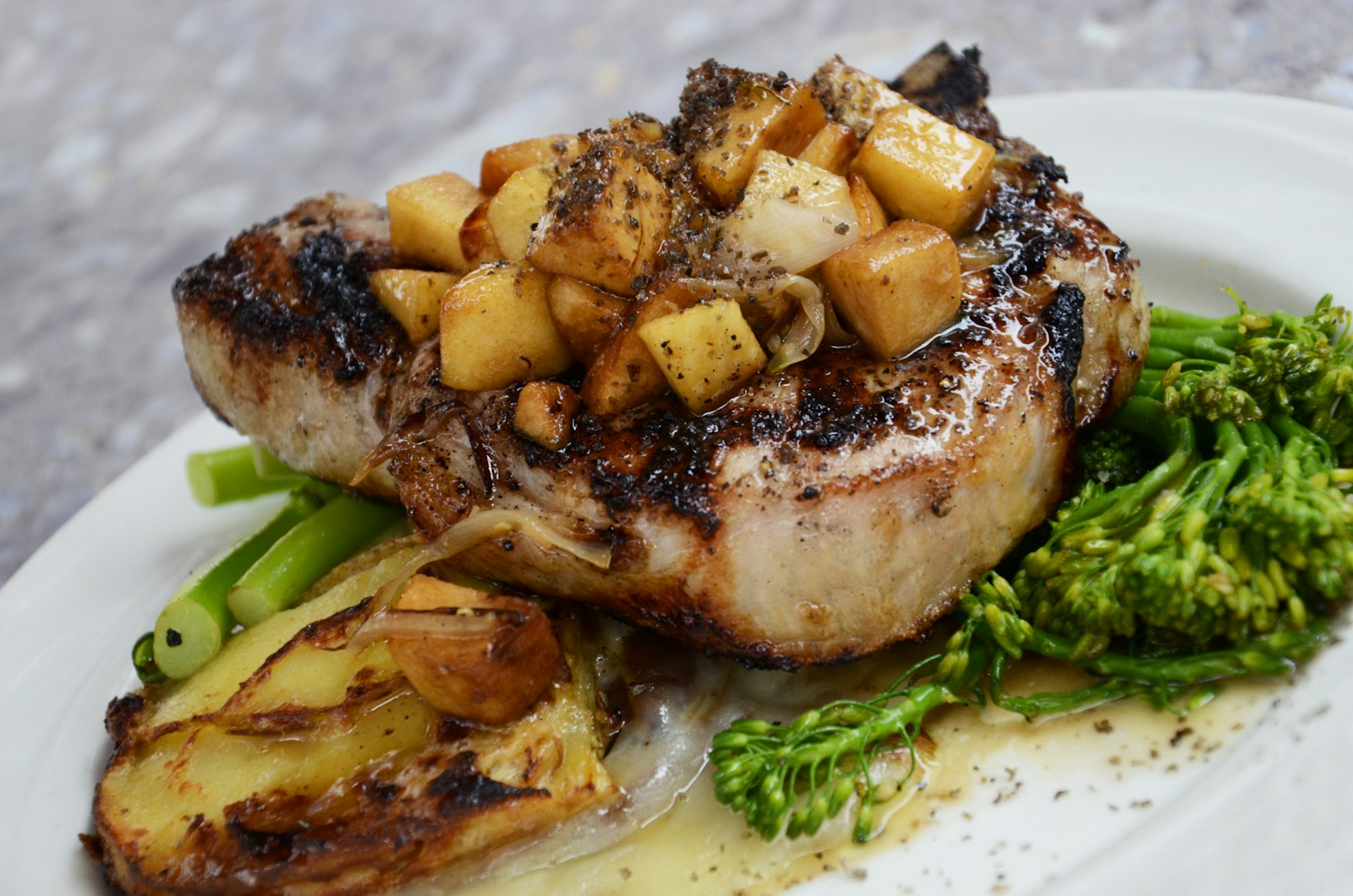 Glazed pork chop with roasted apple and tenderstem broccoli